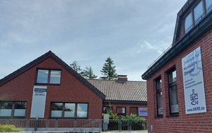 Häuser von außen, rechts ein Banner mit der Aufschrift "Zentrum für Kirchliche Dienste"